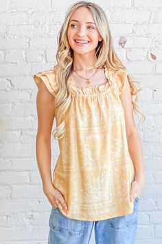 Flutter into spring in style with this bohemian dream of a top. Its cotton blend fabric feels featherlight against your skin as you sway in the warm breeze. Delicate ruffles and an empire waist give it an ethereal quality, while the square neckline and short flutter sleeves keep it flirty. Whether you're dancing at a music festival or strolling through the Saturday market, this top moves with you. Let the vibrant print transport you to exotic lands as you pair it with cutoffs for a casual look o Rachel Clark, There She Goes, New Inventory, Flutter Sleeve Top, Boho Print, Printed Linen, Top Sales, Empire Waist, Flutter Sleeve