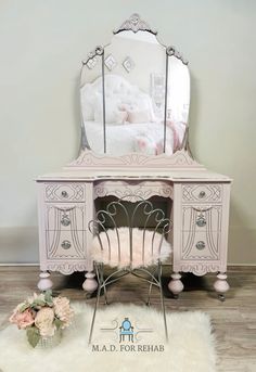 a white desk with a mirror and chair