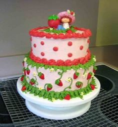 a strawberry shortcake cake on top of a white plate with green and red decorations