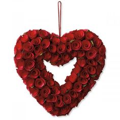 a heart shaped arrangement of red roses on a white background