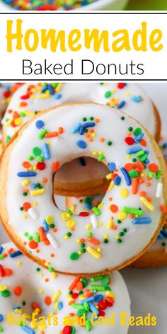 homemade baked donuts with white frosting and sprinkles on top, in front of a plate