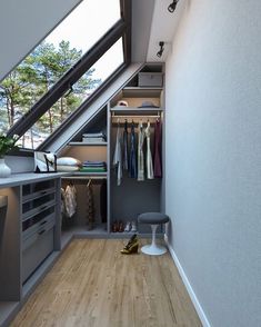 this is an image of a closet in a loft with wood flooring and white walls