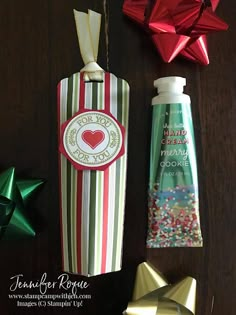 some christmas decorations are on a table and one is wrapped in red, white and green paper