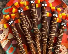 a plate with candy sticks decorated to look like turkeys