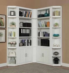 an open bookcase with several books on it in a room that has beige walls and carpeting