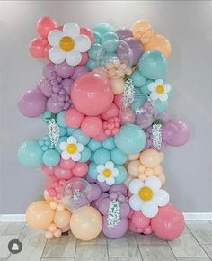 a bunch of balloons that are in the shape of flowers