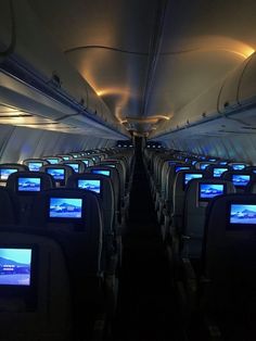 the inside of an airplane with many televisions