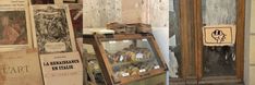 there is a display case with pastries on it in front of an old door