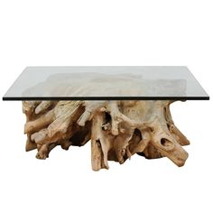 a table made out of driftwood with glass top and bottom layer, on white background