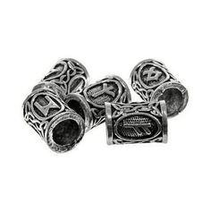 four silver metal beads with celtic designs on each bead, one has a letter in the