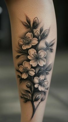 a black and white flower tattoo on the leg