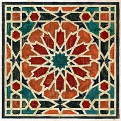 an intricately designed tile in red, green and blue colors with geometric designs on it