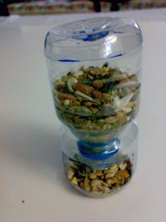 a glass container filled with nuts and seeds