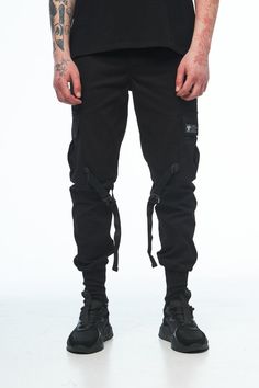 Black mens cargo pants /drop crotch trousers /hip hop pants. If u like urban or streetwear style, you will like this cargo. International Size: S, M, L, XL Material: 100% Cotton Black color Pockets: 6 pcs. Style: Urban  Fit: skinny + cuffs 10 cm Season: Spring / Summer / Autumn SIZE: We use the international dimensional grid to determine the size. But we prefer to sew clothes for each specific customer by his individual measurements. You provide us with your measurements, and we sew clothes specially for you. MEASUREMENTS Please write your height and weight so we can choose the correct size. DELIVERY: All the items are made to order, only for you. It usually takes 1-14 days to make any item. After the items are ready we ship it from our local post office - https://ukrposhta.ua/. It takes 7 Alternative Style Baggy Cargo Pants With Cargo Pockets, Streetwear Sweatpants With Multiple Pockets And Tapered Leg, Streetwear Sweatpants With Multiple Pockets Tapered Leg, Streetwear Cargo Style Parachute Pants With Tapered Leg, Streetwear Tapered Leg Sweatpants With Multiple Pockets, Black Combat Cargo Jeans, Combat Style Cargo Pants With Belt Loops For Streetwear, Utility Cargo Jeans With Tapered Leg For Streetwear, Black Combat Cargo Jeans With Side Pockets