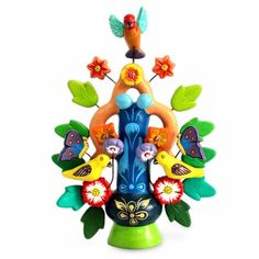 a colorful vase with birds and flowers on it's sides, in the shape of a birdhouse