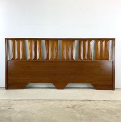 a wooden headboard with slats on top of it