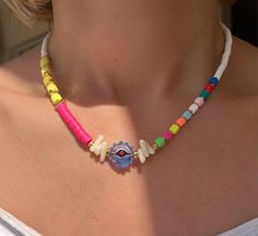 Introducing our unique and handcrafted beaded necklace, featuring a stunning evil eye charm at its center. Perfectly designed for women, this necklace is the perfect addition to any outfit, adding a boho touch to your style. Each necklace is carefully handmade with multicolored Fimo beads and accented with gold metal parts made from brass, creating a one-of-a-kind summer necklace that is sure to turn heads. Our necklace is adjustable, with a length of 44cm (17.3'') and a maximum length of 48cm, Bohemian White Beaded Necklace With Evil Eye, White Bohemian Beaded Necklace With Evil Eye, Bohemian Rainbow Necklaces With Colorful Beads, Bohemian Evil Eye Beads For The Beach, Bohemian Evil Eye Beads For Beach, Multicolor Spiritual Evil Eye Necklace, Bohemian Multicolor Evil Eye Necklace, Vibrant Adjustable Rainbow Necklace, Vibrant Rainbow Adjustable Necklace