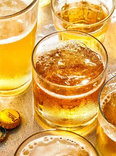 several glasses filled with liquid sitting on top of a table