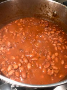 a pot filled with beans sitting on top of a stove