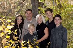 a family posing for a photo in the woods