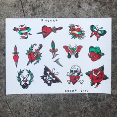 a sheet of stickers with different tattoos on it's back and sides, sitting on the ground