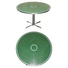 two tables with green and white designs on the top, one has a metal base