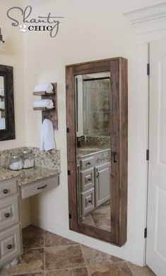 a bathroom with a sink, mirror and shelving unit in the middle of it