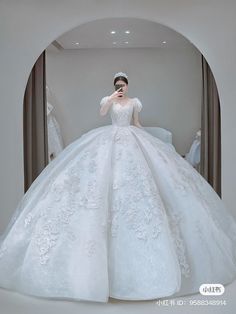 a woman in a white wedding dress is taking a selfie with her cell phone