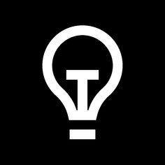 a light bulb with the letter t in it's center on a black background