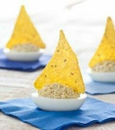 three small bowls filled with food sitting on top of a blue cloth next to each other