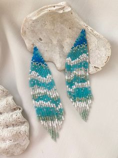 Thoughts about the ocean don't leave me, so I decided to create a piece of the waves for you. These exclusive ocean wave bead earrings are really good at vacation! Long blue and turquoise beaded earrings with sparkling beads remind you of the ocean breeze. It can be a cute gift for your loved ones. Also, you can complement your holiday look with these fringe earrings. ♡ Bead Length - 4.7'' (12 Centimeters) ♡ Total Length - 5.1'' (13 Centimeters) ♡ Width - M-size - 1.2'' (3 Centimeters) L-size - Bohemian Blue Beaded Earrings With Tiny Beads, Turquoise Earrings With Beaded Fringe For Beach, Blue Beaded Earrings For The Beach, Blue Beaded Fringe Earrings For Beach, Turquoise Dangling Bead Drop Earrings, Turquoise Beaded Earrings With Ear Wire, Colorful Blue Beaded Earrings For Beach, Blue Beaded Earrings For Beach, Blue Round Beaded Earrings For Beach