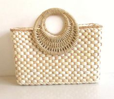 "This adorable handbag is woven with natural straw. It's very sturdy and large enough to fit all of your essential items. Perfect for the spring and summer to compliment your style!  Material: natural straw  Zipper Closure *approximately L 14\"x H 9.5 x D 5\"  Select between: Bag alone Or  Bag with black tassel" Handwoven Rectangular Straw Bag In Neutral Color, Rectangular Handwoven Neutral Straw Bag, White Straw Bag With Bamboo Handle, White Rectangular Straw Bag With Bamboo Handle, White Woven Handheld Straw Bag, White Handheld Woven Straw Bag, Cream Jute Straw Bag Handwoven, Handheld White Woven Straw Bag, Cream Rectangular Straw Beach Bag