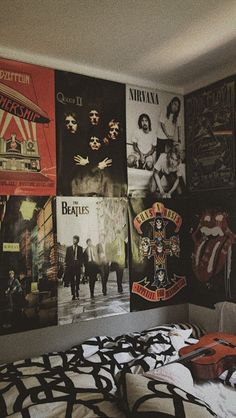 a bedroom with posters on the wall