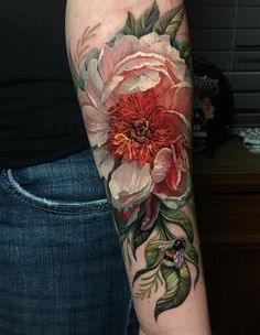 a woman with a flower tattoo on her arm