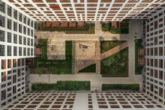 an aerial view of a courtyard with lots of plants on the ground and trees in the middle