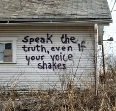 graffiti on the side of a white house reads speak the truth, even your voice shakes