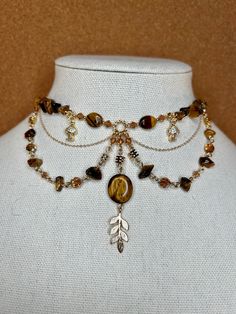 One of a kind Tiger's Eye choker necklace with nature inspired mushroom and gold leaf details. Made with 14k gold elements that will last. Message me for custom sizing, we are size inclusive! Gay Prom, Chokers Necklace, Prom Outfit, Gold Leaf Necklace, Turquoise Choker, Cottagecore Fairy, Fairy Necklace, Turquoise Bead Necklaces, Gold Gemstone Ring