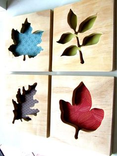 four pieces of wood with different shapes and sizes of leaves on them, mounted to the wall