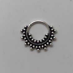 "These are so pretty and light. Made is 925 sterling silver with tribal details. The rings are all 10mm (1cm or .40\") in diameter. The wire is 18 gauge. They are only finished on one side since each one is made BY HAND so there may be very slight differences. One of the images contains numbers to specify which you would like from the drop down menu." Adjustable Round Bohemian Nose Rings, Bohemian Sterling Silver Body Jewelry, Nickel Free Silver Piercings, Nickel Free Round Silver Piercings, Nickel-free Round Silver Piercings, Bohemian Nickel-free Round Septum Ring, Adjustable Bohemian Sterling Silver Body Jewelry, Adjustable Silver Toe Ring Piercings, Silver Bohemian Adjustable Cartilage Earrings