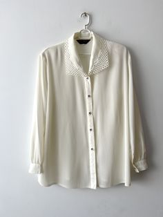 80s Women's formal blouse Pale Champagne sheer blouse Ivory white long sleeve top Vintage grandma blouse with shoulder pads Size Extra large N.B. Real color might slightly differ from picture. Estimated size: XL Measurements: (lying flat) Length - 29"/ 73.5 cm Shoulders:  17"/ 43.3 cm Sleeve - 24"/ 61 cm Pit to pit: 24"/ 61 cm Waist: 24"/ 61 cm Please check measurements to insure a proper fit. Remember to allow yourself some extra room for movement. You can compare these with something from your Long Sleeve Tops With Sheer Sleeves For Office, Office Tops With Sheer Long Sleeves, Long Sleeve Sheer Tops For Office, Sheer Long Sleeve Tops For Office, Office Blouse With Long Sheer Sleeves, Spring Collared Top With Sheer Sleeves, Classic Office Tops With Sheer Sleeves, Classic Sheer Sleeve Tops For Office, Elegant Button-up Tops With Sheer Sleeves