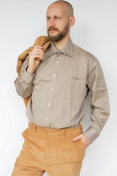 "Brown button up men's shirt Vintage cotton plus size casual formal dress shirt with chest pocket High quality long sleeved cotton shirt, has one chest pocket. Will look great with anything, especially in formal events. In great vintage condition. Measured laying flat - double for circumference: From armpit to armpit: 26\" (66 cm) Length: 33.5\" (85 cm )   Sleeve length: 24\" (61 cm) Tag: Daniel Cremieux, France Model in the photos is size L More from Vintage Finds: https://www.etsy.com/shop/som Semi-formal Shirt With Spread Collar And Pockets, Formal Shirt With Pockets And Lapel Collar, Classic Semi-formal Shirt With Pockets, Formal Shirt With Spread Collar And Pockets, Formal Long Sleeve Shirt With Pockets, Formal Button-up Shirt With Pockets, Semi-formal Dress Shirt With Welt Pockets, Semi-formal Long Sleeve Dress Shirt With Welt Pockets, Classic Formal Dress Shirt With Pockets