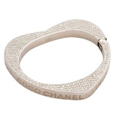 This bracelet has a heart shape and is encrusted with Swarovski crystals. "Coco Chanel” engraved on the sides. COLOR: Silver MATERIAL: Metal, crystal. MEASURES: Inside opening: 2.5” by 2”. Full bracelet diameter 3”, full circumference 9” ITEM CODE: 08 P COMES WITH: Chanel box. CONDITION: Good, a couple rhinestones missing. Faint hair line scratches. Made in Italy Heart Bangle Bracelet, Swarovski Heart, Chanel Box, Swarovski Crystal Hearts, Hair Line, Y2k Jewelry, Vintage Chanel, Crystal Heart, Heart Jewelry