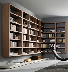 a room with bookshelves and a chair on the floor in front of it