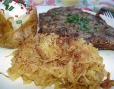 the meal is prepared and ready to be eaten on the plate, including steak, potatoes, and mashed potatoes