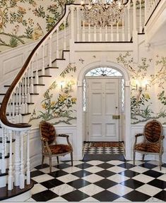 the foyer is decorated in white and black checkered flooring with floral wallpaper