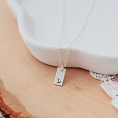 Initial Tiny Rectangle Tag Necklace-Rockaway Gypsea Minimalist Hand Stamped Charm Necklace As Gift, Minimalist Sterling Silver Charm Necklace For Best Friend, Hypoallergenic Minimalist Initial Necklace For Everyday, Everyday Hypoallergenic Minimalist Initial Necklace, Dainty Stamped Charm Necklaces For Everyday, Minimalist Rectangular Necklaces As Gift For Her, Minimalist Hand Stamped Rectangular Pendant Necklace, Minimalist Rectangular Necklace As Gift For Her, Minimalist Custom Name Rectangular Jewelry