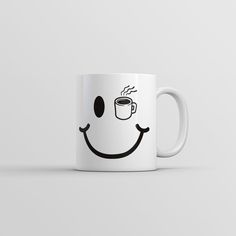 a coffee mug with a smiley face drawn on it