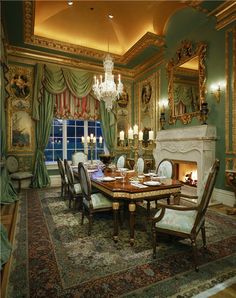 a fancy dining room with green walls and gold trimmings, ornate chandelier