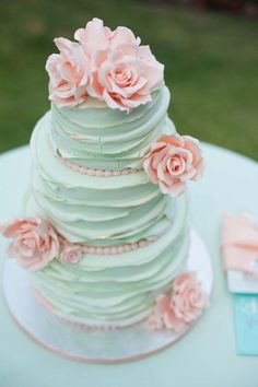 a wedding cake with pink flowers on top