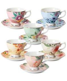 six tea cups and saucers with flowers painted on the sides, all in different colors